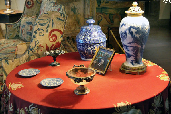 Round side table with ceramic antiques in dining room at Rough Point. Newport, RI.