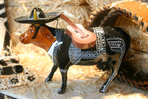Figurine of cow with guitar in Mexican suit. San Antonio, TX.
