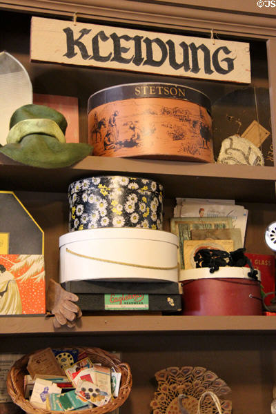 Hats, gloves & hat boxes under Kleidung (clothes) sign in Forke Store at Conservation Plaza. New Braunfels, TX.