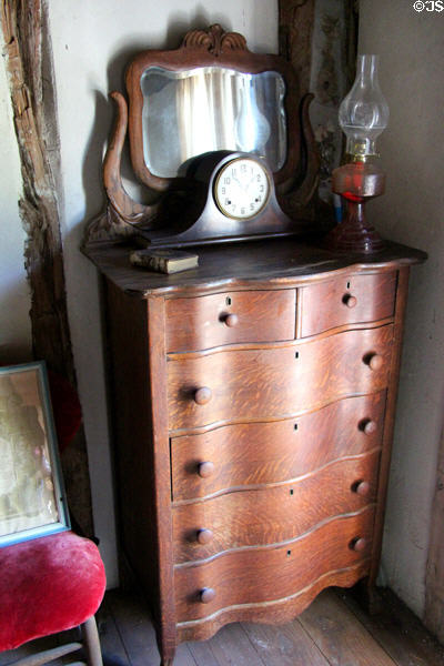 Bowfront chest of drawers & mirror in carved frame in Locksted-Seibold house at Conservation Plaza. New Braunfels, TX.