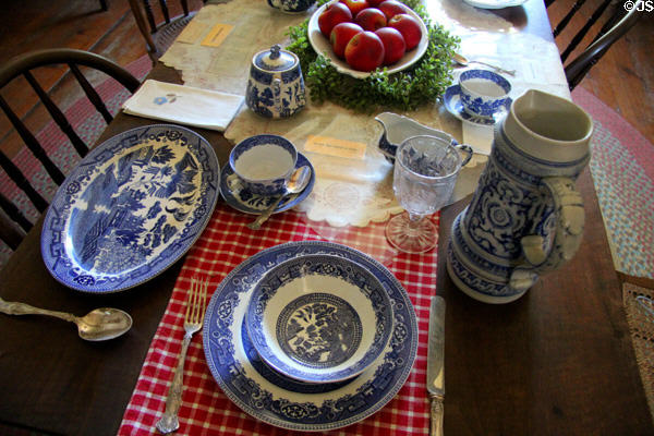 Place setting with blue willow china in Baetge House at Conservation Plaza. New Braunfels, TX.
