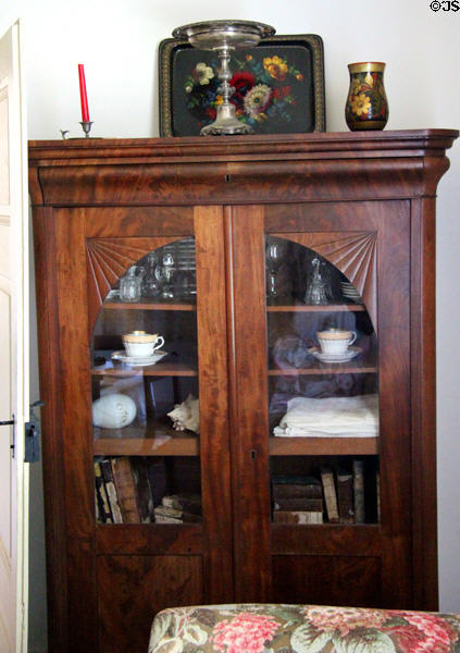 Glass fronted display cabinet in Baetge House at Conservation Plaza. New Braunfels, TX.