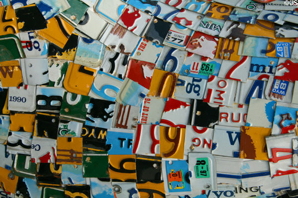 License plate pieces covering Licensed to Boot street art. Cheyenne, WY.