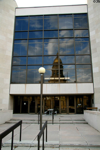 State Capitol reflected in entrance of Herschler Building. Cheyenne, WY.
