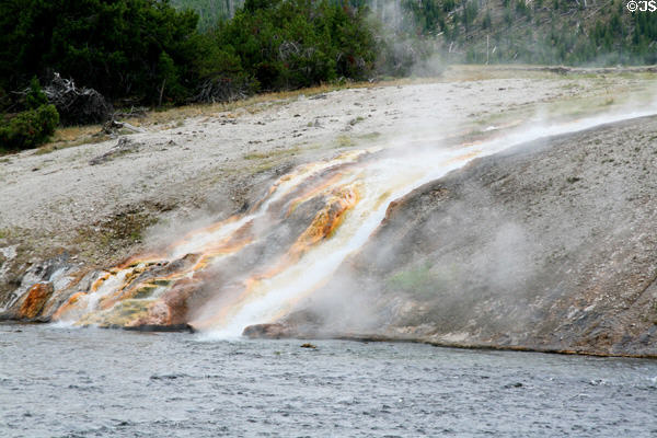 Waterfall from Excelsior Geyser flows into Firehole River at Yellowstone National Park. WY.
