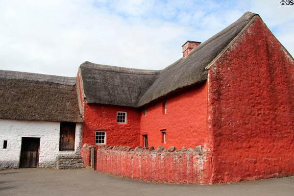Red painted Kennixton Farmhouse with straw roof at St Fagans National Museum of History. Cardiff, Wales.