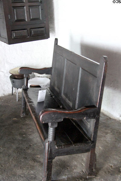 Simply furnished interior with bench of Nantwallter Cottage at St Fagans National Museum of History. Cardiff, Wales.