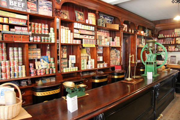 Wood serving counter & shelving with varied goods, including a coffee grinder, at Gwalia Supply Co. at St Fagans National Museum of History. Cardiff, Wales.