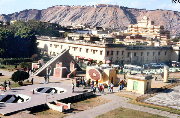 Jaipur's observatory, palace & fort on distant hill. India.