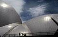 Walking across a bridge near roof of Sydney Opera House. Sydney, Australia.
