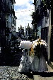 Two women in regional dress carrying cloth through the streets of Salvador. Brazil.