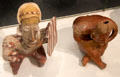 Ameca-Etzatlán style earthenware seated figures 1st with shield & 2nd as hunchback from Jalisco, Mexico at Gardiner Museum. Toronto, ON.
