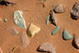 Patterns of rocks in the red sand. PE.