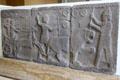 Basalt relief carving of lion hunt scene on foot & horse-drawn chariot from ruins of city near Sakçegözü in Turkey at Pergamon Museum. Berlin, Germany.