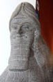 Detail of face of Assyrian schedu lamassu, a human headed, winged lion with horned crown cast from British Museum at Pergamon Museum. Berlin, Germany.