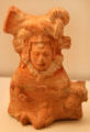 Mayan ceramic sitting female with knotted headdress from Mexico at Museum of America. Madrid, Spain