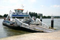 Cars unloading from ferry across Seine River. Jumièges, France.