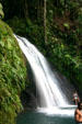 Bathing in waterfall pool of Cascade aux Ecrivisses beside route de Traversée. Guadeloupe.