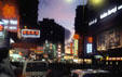 Neon lights of a Kowloon street at sunset. Hong Kong, Hong Kong.