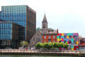 Immaculate Heart of Mary Church & converted warehouse with puzzle-piece mural on City Quai of River Liffey. Dublin, Ireland.