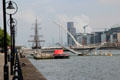 Jeanie Johnstone Tall Ship with Capital Dock complex beyond Samuel Beckett Bridge over River Liffey. Dublin, Ireland.