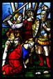 Beheading a saint in stained-glass scene in Duomo. Milan, Italy.