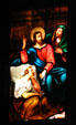 Story of Christ in stained-glass scene in Duomo. Milan, Italy.