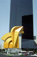 Bright yellow El Caballito sculpture in front of Torre Caballito skyscraper on Paseo de la Reforma. Mexico City, Mexico.