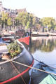 Barges & houseboats on the Amstel near opera. Amsterdam, Netherlands.