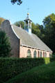 Characteristically Dutch roof line & simple bell tower on Chapel from 's-Heerenoek at Openlucht Museum. Arnhem, Netherlands.