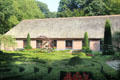 Thatched roof building with formal garden at Arnhem Openlucht Museum. Arnhem, Netherlands.