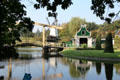 Village view with windmill, mill pond & lifting footbridge at Arnhem Openlucht Museum. Arnhem, Netherlands.