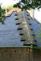 Building with metal roof with design created with thatching at Arnhem Openlucht Museum. Arnhem, Netherlands.