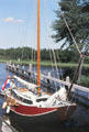 Sailboat docked in canal South of Giethoorn. Giethoorn, Netherlands.