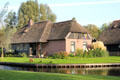Home with thatched roof on canal. Giethoorn, Netherlands.