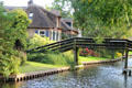 Wooden pedestrian bridge over canal. Giethoorn, Netherlands.