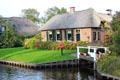 Homes with thatched roofs along canal. Giethoorn, Netherlands.
