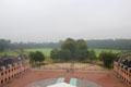 Wings of Het Loo Palace with grounds & forest in the distance viewed in morning mist. Het Loo, Netherlands.