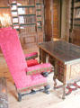 Red damask wing-back arm chair in library. Het Loo, Netherlands.