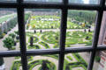 Formal gardens viewed through multi-paned window. Het Loo, Netherlands.