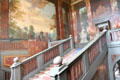 Grand Staircase, with mural depicting richly dressed Ottoman men, standing behind painted balustrade. Het Loo, Netherlands.