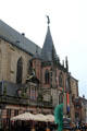 Spire of St. Michael's Church topped with statue of St. Michael & Glass Angel by Herman Lamers in foreground. Zwolle, Netherlands.