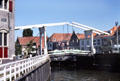 Lift bridge above the city canal that leads from the harbor in Enkhuizen. Netherlands.