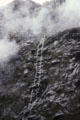 Waterfall trickles down rocks near Milford Sound. New Zealand.