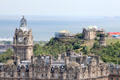 Balmoral Hotel with monuments on Calton Hill beyond. Edinburgh, Scotland.