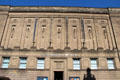 Row of sculpted figures by Hew Lorimer at National Library of Scotland. Edinburgh, Scotland.