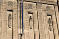 Sculpted figures by Hew Lorimer under rondels by E. Dempster on facade of National Library of Scotland. Edinburgh, Scotland.
