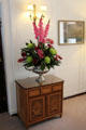 Anteroom cabinet with flower arrangement on Royal Yacht Britannia. Edinburgh, Scotland.
