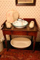 Wash stand, pitcher & basin plus hot water bottles at Brodie Castle. Brodie, Scotland.