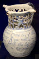 Ceramic puzzle jug used for drinking games, probably made in Liverpool, at Bristol Museum & Art Gallery. Bristol, England.